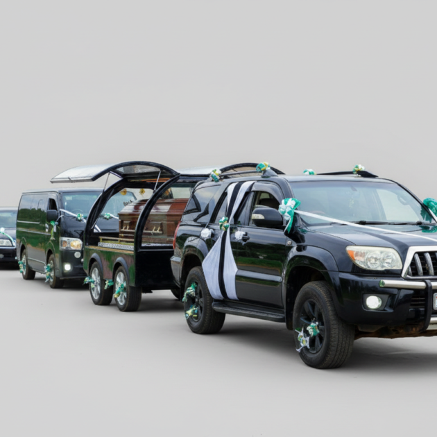 Black Executive SUV towing a full glass funeral chariot with three-way opening wings and luminous interior lighting